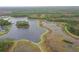 Aerial view of community with lake, walking paths, and conservation area at 4077 Broad Porch Run, Land O Lakes, FL 34638