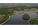 Aerial view of a peaceful lake community with lush greenery at 4077 Broad Porch Run, Land O Lakes, FL 34638