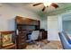 Home office with built-in desk, ceiling fan, and hardwood floors at 5220 Butterfly Shell Dr, Apollo Beach, FL 33572