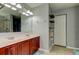 Double vanity bathroom with wood cabinets and linen closet at 5220 Butterfly Shell Dr, Apollo Beach, FL 33572