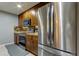Kitchen boasts stainless steel refrigerator and granite countertops at 5220 Butterfly Shell Dr, Apollo Beach, FL 33572
