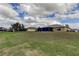 Landscaped backyard showcasing the home and neighborhood view at 5220 Butterfly Shell Dr, Apollo Beach, FL 33572