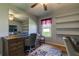 Bright home office with built-in desk and shelving, ceiling fan and hardwood floors at 5220 Butterfly Shell Dr, Apollo Beach, FL 33572