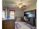 Bright home office with built-in desk and shelving, ceiling fan and hardwood floors at 5220 Butterfly Shell Dr, Apollo Beach, FL 33572