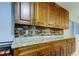 Kitchen with wood cabinets and granite countertops at 5220 Butterfly Shell Dr, Apollo Beach, FL 33572