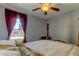 Bedroom with wooden post bed and window view at 5220 Butterfly Shell Dr, Apollo Beach, FL 33572