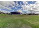 Large backyard with home and neighboring houses visible at 5220 Butterfly Shell Dr, Apollo Beach, FL 33572