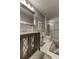 Updated bathroom with a walk-in shower, modern vanity, and gray tile flooring at 5220 Butterfly Shell Dr, Apollo Beach, FL 33572
