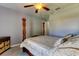 Bedroom with wooden post bed and ceiling fan at 5220 Butterfly Shell Dr, Apollo Beach, FL 33572