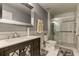 Updated bathroom with a walk-in shower, modern vanity, and gray tile flooring at 5220 Butterfly Shell Dr, Apollo Beach, FL 33572