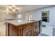 Kitchen island with granite countertops and stainless steel sink at 5220 Butterfly Shell Dr, Apollo Beach, FL 33572