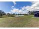 Spacious backyard with pond views and lush landscaping at 5220 Butterfly Shell Dr, Apollo Beach, FL 33572
