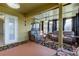 Bright sunroom featuring ample seating and access to the outdoors at 5220 Butterfly Shell Dr, Apollo Beach, FL 33572