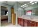 Double vanity bathroom with wood cabinets and mirror at 5220 Butterfly Shell Dr, Apollo Beach, FL 33572