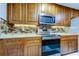 Modern kitchen with stainless steel range and granite countertops at 5220 Butterfly Shell Dr, Apollo Beach, FL 33572