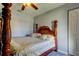 Bedroom with wooden post bed and ceiling fan at 5220 Butterfly Shell Dr, Apollo Beach, FL 33572