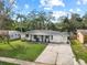 Aerial view of a house with a yard and driveway at 1016 Beachwood Ave, Clearwater, FL 33759