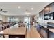 Kitchen with an island, dark cabinets, and a view of the living room at 13010 Lily Chapel Ct, Riverview, FL 33579