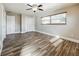 Bright bedroom with wood-look floors, double closet, and ceiling fan at 2063 Dawn Dr, Clearwater, FL 33763