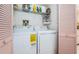 Bright laundry room with washer, dryer, and shelving at 2700 Bayshore Blvd # 9104, Dunedin, FL 34698