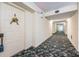 Light and bright hallway with carpeted floors and access to unit at 2700 Bayshore Blvd # 9104, Dunedin, FL 34698