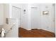 Bright hallway with wood floors, leading to bedrooms and other rooms at 4630 Mirabella Ct, St Pete Beach, FL 33706