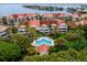 Aerial of waterfront community with pool and lush landscaping at 4630 Mirabella Ct, St Pete Beach, FL 33706