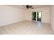 Bright bedroom with tile floors and sliding doors at 4630 Mirabella Ct, St Pete Beach, FL 33706
