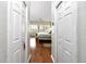 Hallway with hardwood floors and doors leading to bedrooms at 4630 Mirabella Ct, St Pete Beach, FL 33706