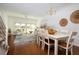 Open concept dining room with hardwood floors and white furniture at 4630 Mirabella Ct, St Pete Beach, FL 33706