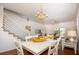 Charming dining area with white table and chandelier at 4630 Mirabella Ct, St Pete Beach, FL 33706