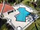 Community pool with lounge chairs and covered seating at 4630 Mirabella Ct, St Pete Beach, FL 33706