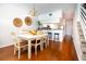 Light and airy dining room with hardwood floors and white furniture at 4630 Mirabella Ct, St Pete Beach, FL 33706