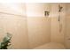 Large walk-in shower with tiled walls and a handheld showerhead at 4630 Mirabella Ct, St Pete Beach, FL 33706
