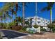 Inviting condo building with palm trees and landscaping at 4630 Mirabella Ct, St Pete Beach, FL 33706