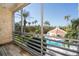 Balcony overlooking a pool and lush tropical landscape at 4630 Mirabella Ct, St Pete Beach, FL 33706