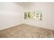 Spacious bedroom with window, carpet, and plenty of natural light at 4630 Mirabella Ct, St Pete Beach, FL 33706