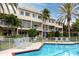 Community pool with lounge chairs and lush landscaping at 4630 Mirabella Ct, St Pete Beach, FL 33706