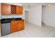 Wet bar with wood cabinets, granite countertop, and mini-fridge at 4630 Mirabella Ct, St Pete Beach, FL 33706