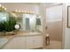 Double vanity bathroom with updated cabinets and a walk-in shower at 4630 Mirabella Ct, St Pete Beach, FL 33706