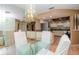 Dining room with glass table, white chairs, and a chandelier at 506 Chittingford Close, Palm Harbor, FL 34683