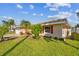 House exterior with red shutters and green lawn at 529 Johns Pass Ave, Madeira Beach, FL 33708