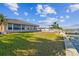 Waterfront backyard with grassy area, patio furniture and dock at 529 Johns Pass Ave, Madeira Beach, FL 33708