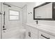 Modern bathroom with white cabinets, quartz countertop, and tiled shower at 7521 Tall Tree Ct, Port Richey, FL 34668