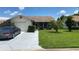 House exterior, featuring a garage and well-maintained lawn at 8101 Casuarina Dr, Port Richey, FL 34668