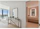 Modern entryway with marble console, mirror, and access to bedroom and bathroom at 1000 Water St # 1702, Tampa, FL 33602