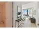 Bright entryway with modern console table, mirror, and views into bedroom and bathroom at 1000 Water St # 1702, Tampa, FL 33602