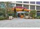 Building entrance with lush landscaping and seating at 1000 Water St # 1702, Tampa, FL 33602