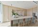 Modern kitchen with light wood cabinets, marble island, and high-end appliances at 1000 Water St # 1702, Tampa, FL 33602