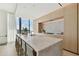 Modern kitchen with marble countertops and island, stainless steel appliances, and light wood cabinetry at 1000 Water St # 1702, Tampa, FL 33602